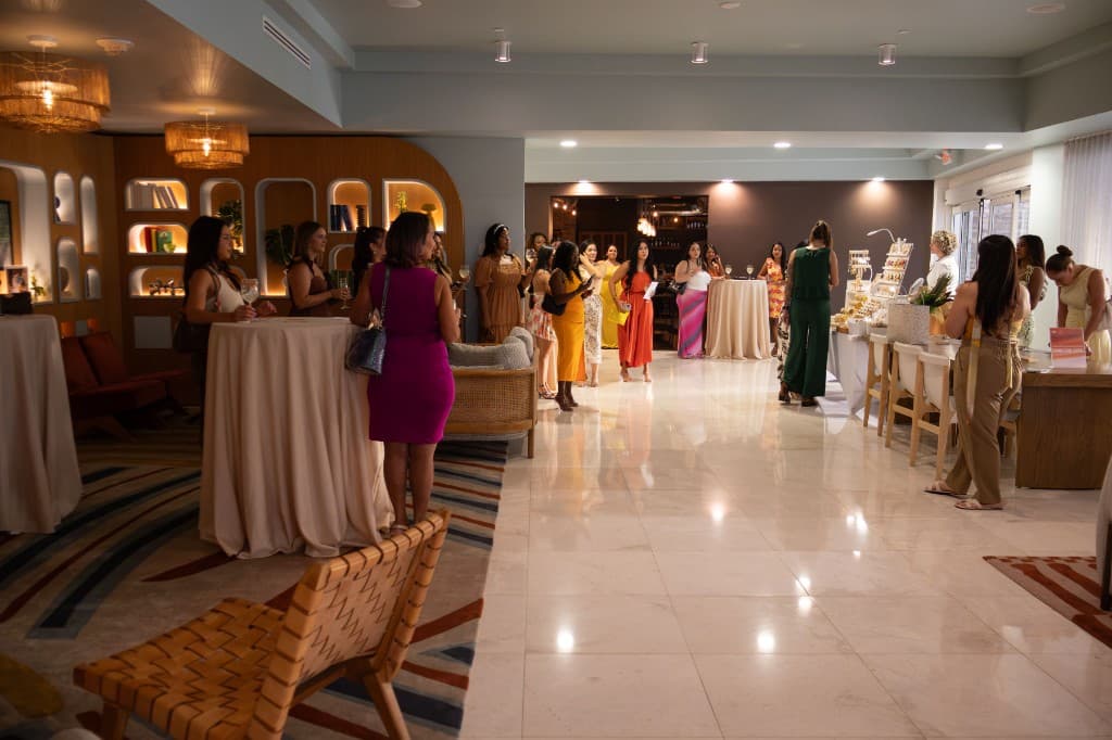 Women gathering in a bright Orlando lounge at a She Cultivates community event