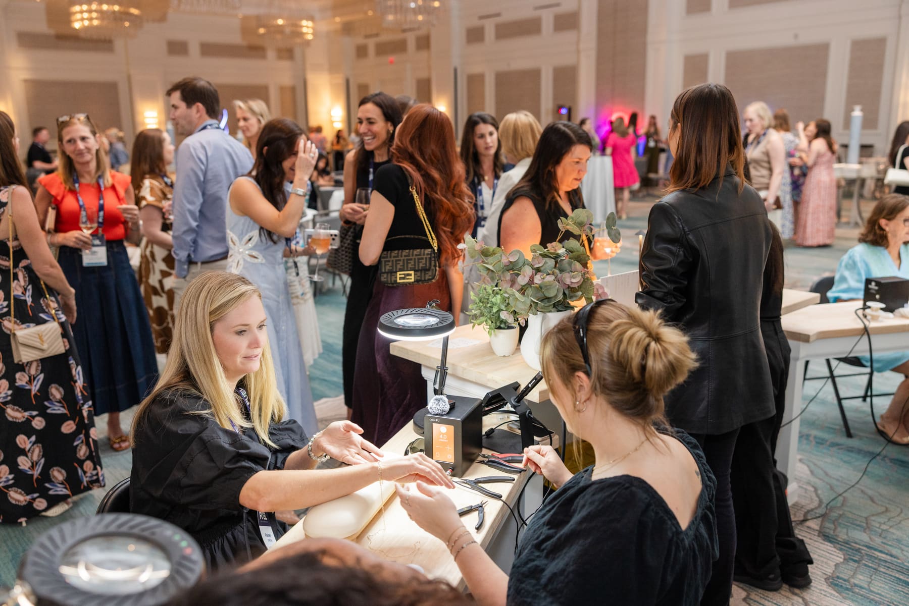 High-touch permanent jewelry moment at a brand activation