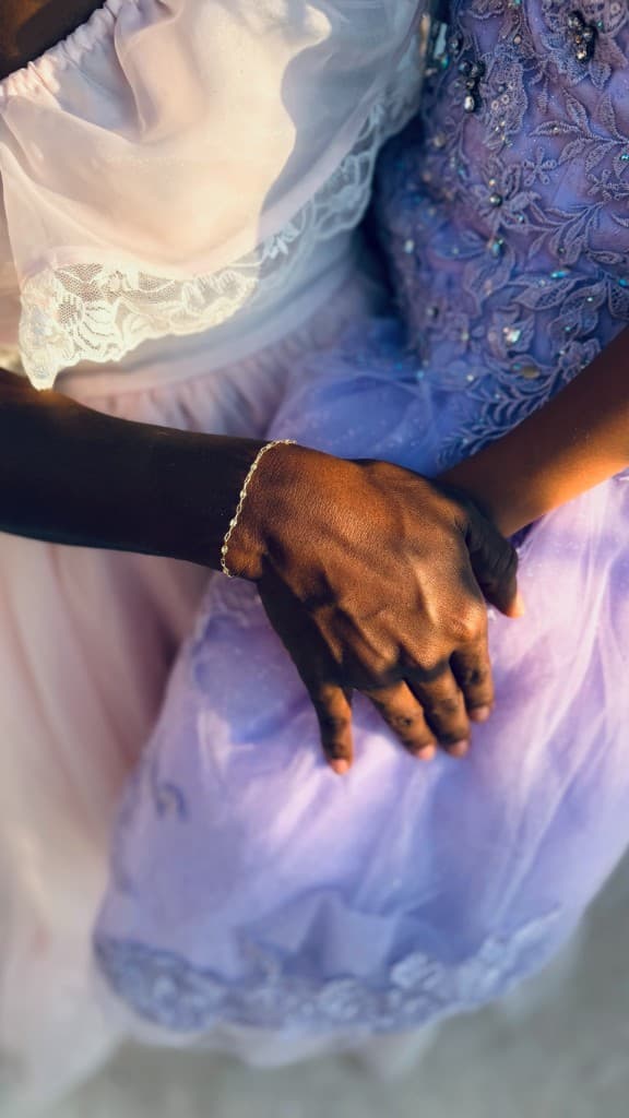 A guest's hand wearing a delicate gold permanent jewelry bracelet at the Stone Haven Bridal Expo.